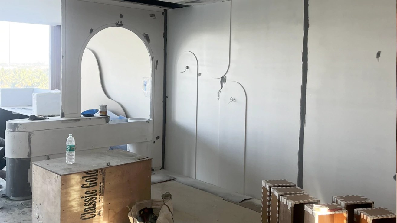 Before — bare construction shell with arched niche outline