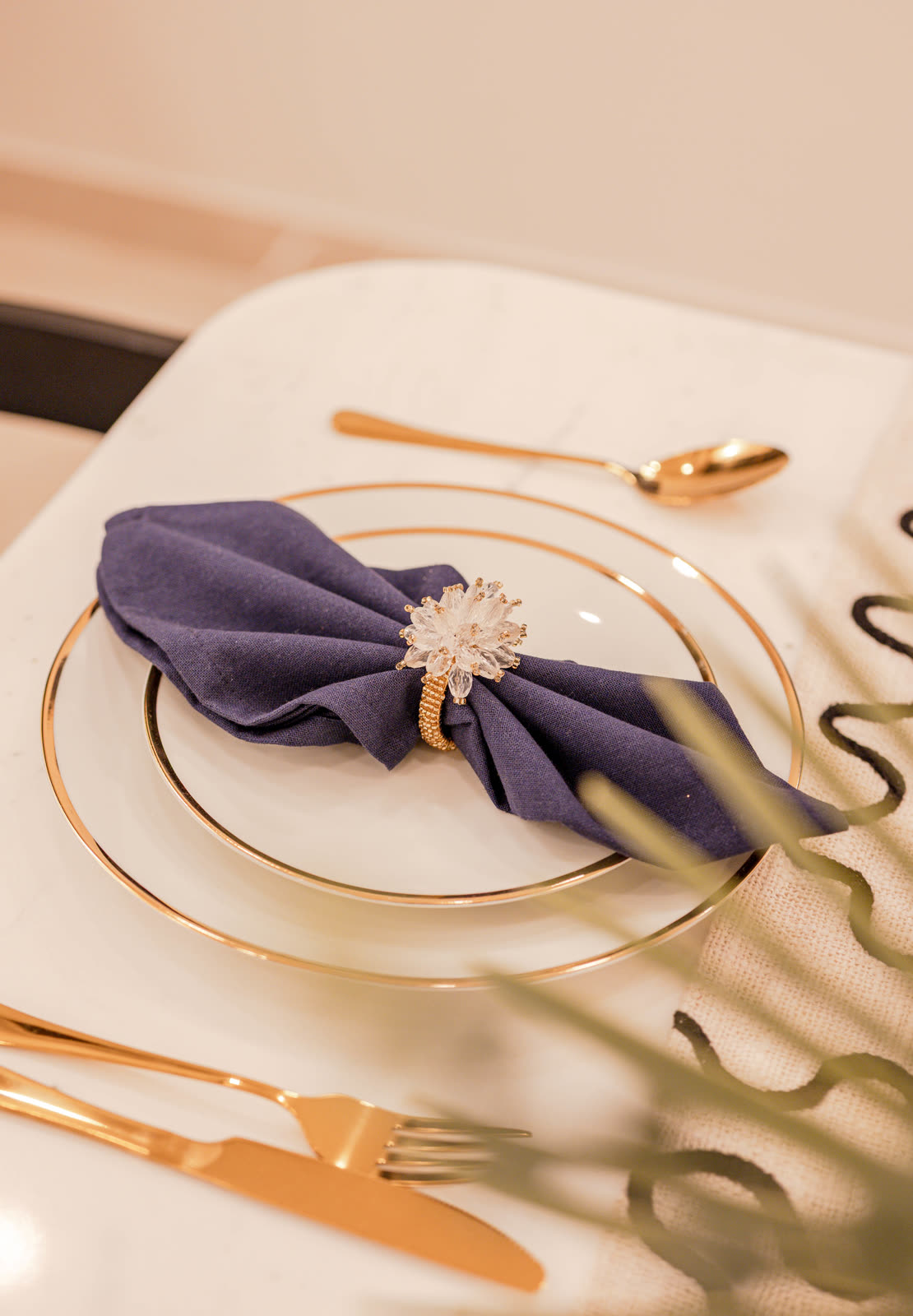 Beige Experience Centre — Dining Setups — Gold-rimmed plate · navy linen