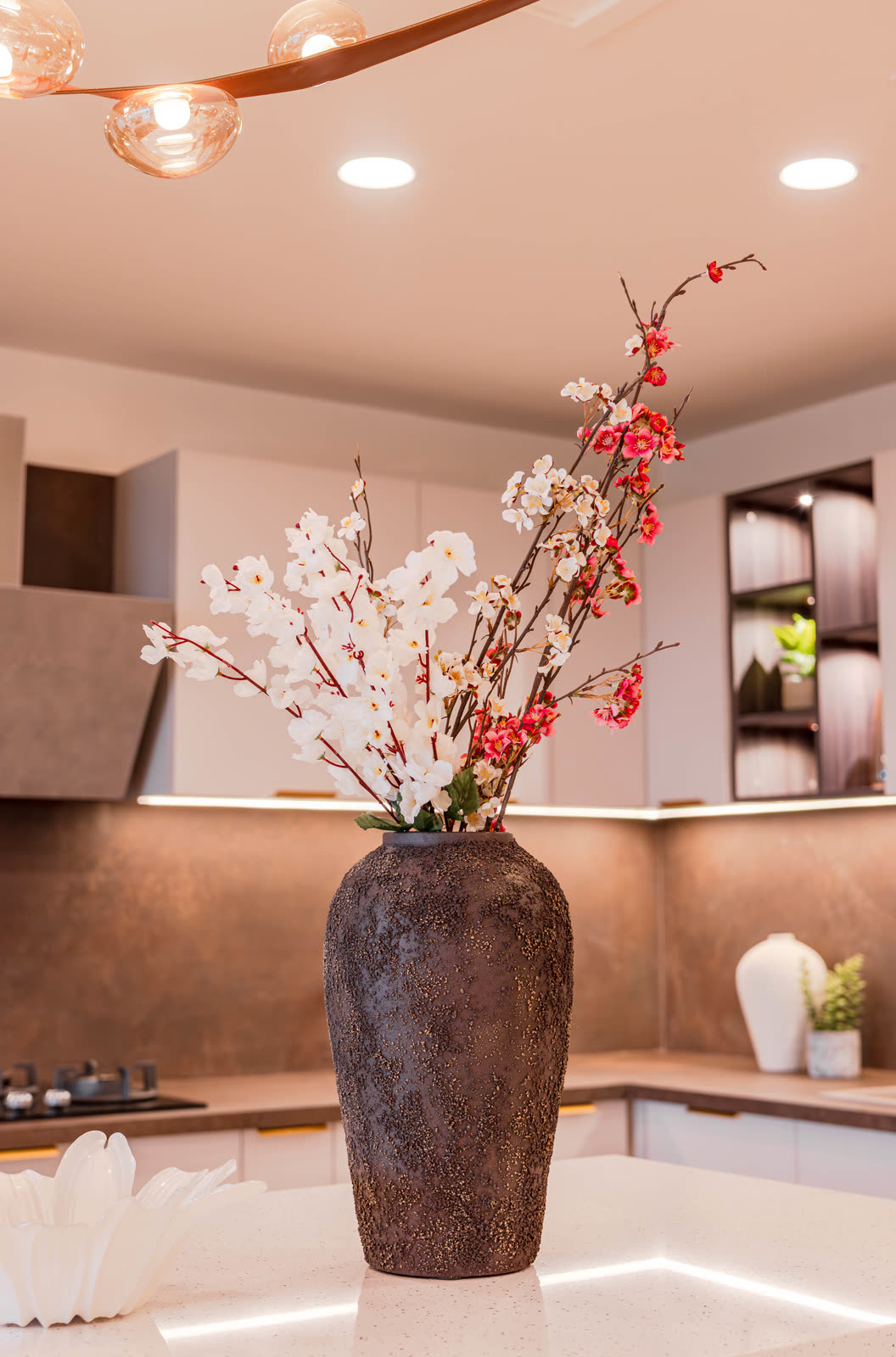 Beige Experience Centre — Modular Kitchen — Textured backsplash · under-cabinet light