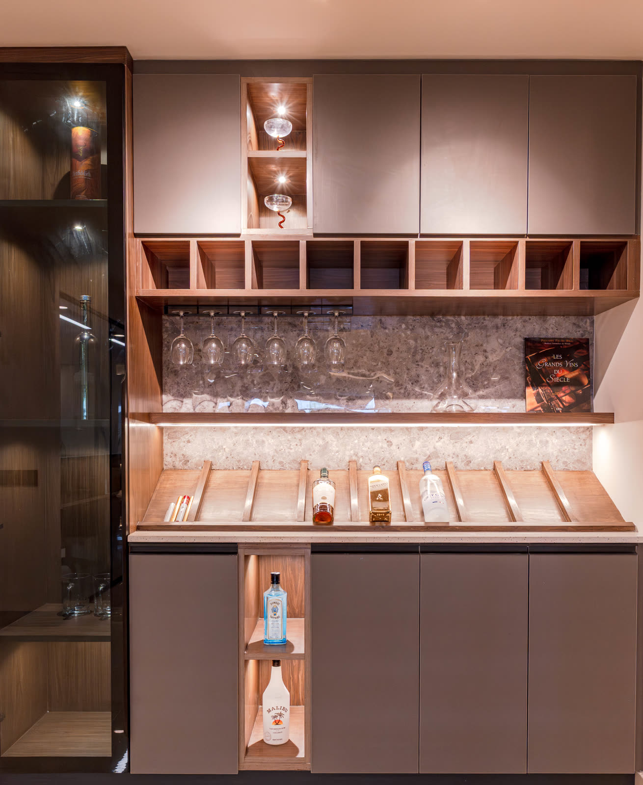 Beige Experience Centre — Bar Unit — Walnut wine racks · lit bottles